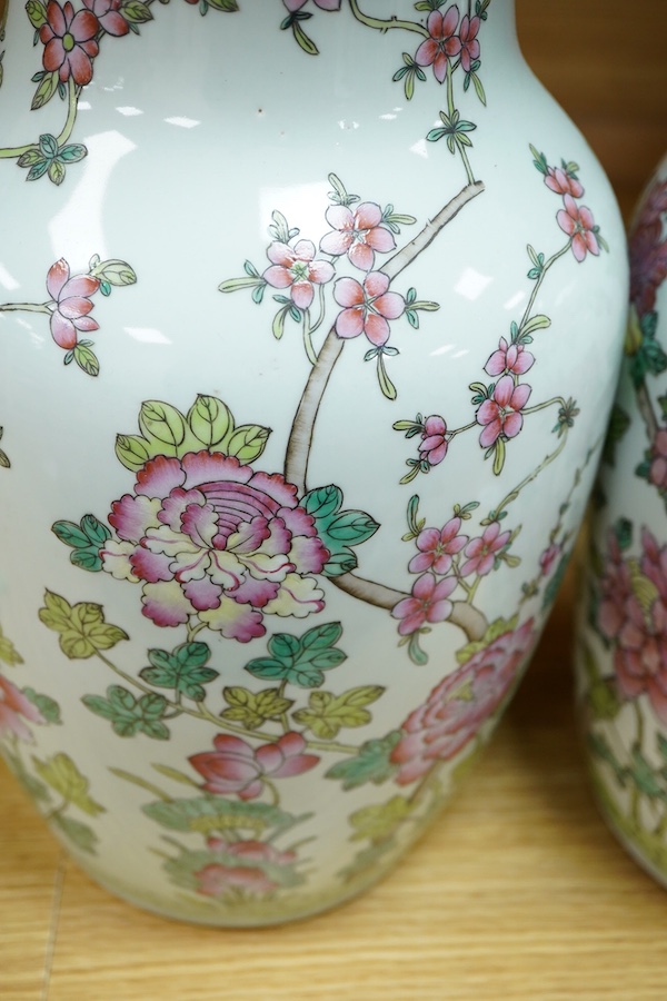 A pair of Chinese famille rose baluster vases decorated with flowers, 36cm high